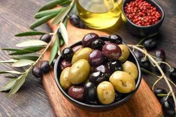 Different kinds of olives with olive oil and herbs 
