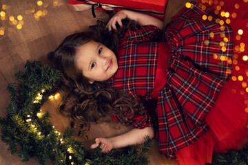 beautiful girl lies on the floor near the Christmas tree