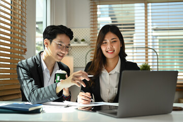 Young businessman sharing ideas business strategy, explaining new strategies on digital tablet to his business partner