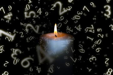 numerology, a candle burns in the dark, sparkling surrounded by numbers