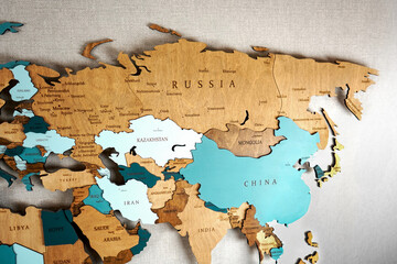 Continent Eurasia on the political map. Wooden world map on the wall, Russia, Kazakhstan, China, Mongolia, Iran