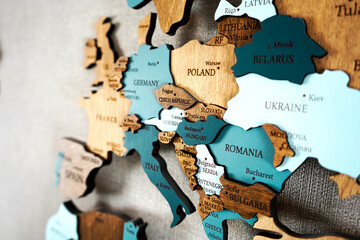Europa on the political map. Wooden world map on the wall. Germany, Poland, Romania, Ukraine,...
