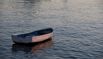 Small boat on the shore at sunset