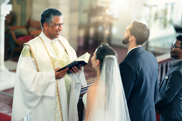 Wedding, couple and priest with a bible in church praying to God with a Christian pastor reading...