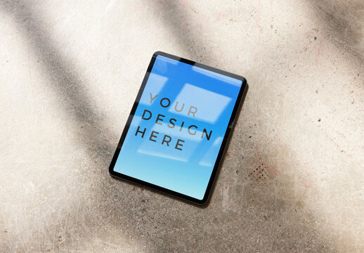 Vertical Smart Tablet Mockup on a Concrete Floor With Window Light