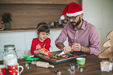 Father and daughter baking Christmas cookies