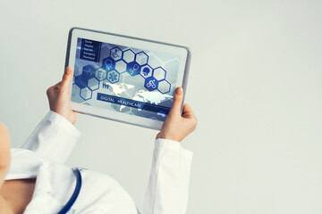 Close of female doctor hands working with tablet pc computer