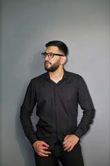 Obraz premium Young handsome business man dressed in casual denim shirt with smartwatch on wrist