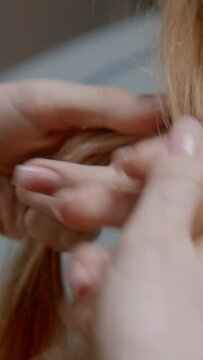 Three women braiding each other's hair