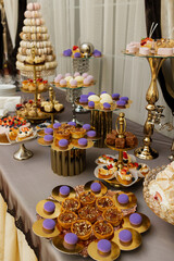 Table with cakes, sweets, candy, buffet. Dessert table for a party goodies for the wedding banquet area. Close up candy bar. Decorated delicious.