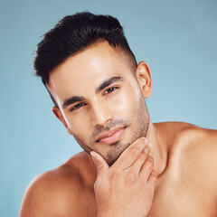 Skincare, portrait and man with idea for beauty, wellness and health against a blue studio...
