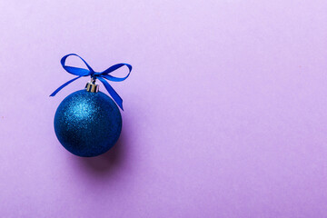Christmas ball on colored background. decoration bauble with ribbon bow with copy space
