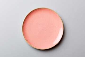 Top view of isolated of colored background empty round pink plate for food. Empty dish with space for your design