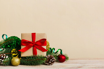 New Year Christmas mood, gift box, branches of a christmas tree, New Year decorations on a colored background