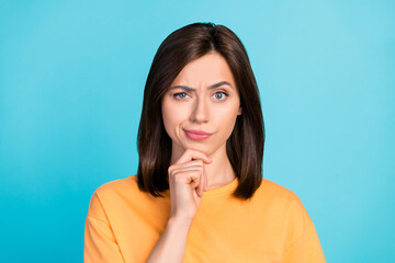 Photo of suspicious strict nice girl with straight hairdo wear yellow t-shirt hold finger on chin...