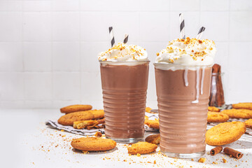 Snickerdoodle milkshake, protein shake or smoothie. Autumn cocoa cookie drink with snickerdoodle scones crumble, whipped cream and cinnamon spicees, white background copy space