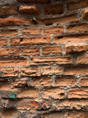 Unfinished red brick wall