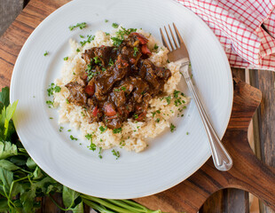 Beef curry with brown rice on a plate