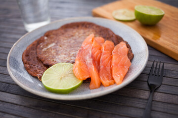 salted salmon fillet with rye pancakes and lime