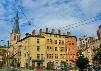 Fototapeta na wymiar Very old colorful buildings of old Lyon, France, with the splendid church Saint Paul.