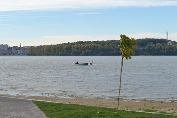 Floating boat on the lake. Kayak training on the lake. Forest background