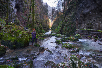 Fototapeta premium Nature photographer lady in a canyon with a river