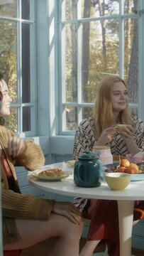 Girls having a conversation during breakfast 