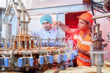 Beverage worker in drink factory found machine breakdown and inform to service team for repair