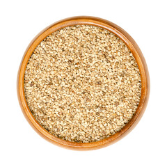 Unhulled sesame seeds, benne in a wooden bowl. Seeds of Sesamum indicum, with rich and nutty flavor. Common ingredient in cuisines around the world, with one of the highest oil content of any seed.