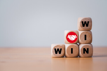 Win and win wording with hand shaking icon on wooden cube block for success and business deal...