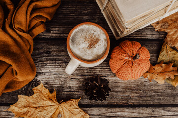Hot spicy coffee and pile of old books on wooden background