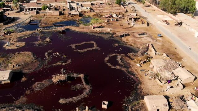 Aerial view of rural life in Pakistan's Daharki city in Sindh province with old houses and roads.