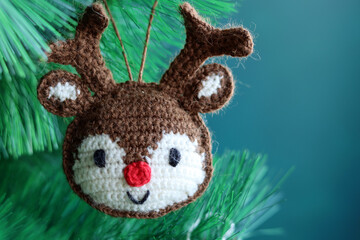 Crochet amigurumi Christmas toy. Close up photo of hand made  staffed doll. Christmas decoration ideas. 