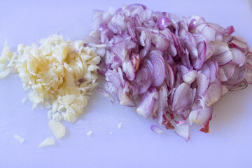 Sliced ​​onion and garlic on a cutting board for seasoning