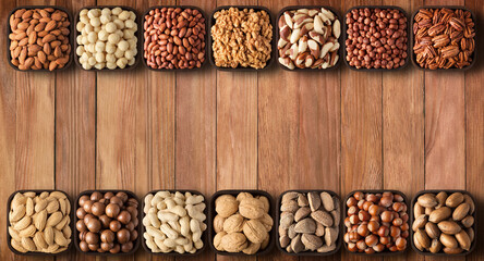 various seeds and nuts background, top view. healthy snacks on wooden table with copy space