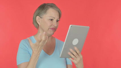 Old Woman Reacting to Loss on Tablet on Red Background