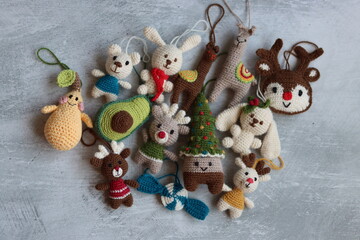 Christmas crochet patters. Cute crochet toys top view photo. Beautiful amigurumi animals. Home made Christmas gifts. Light grey background with copy space. 