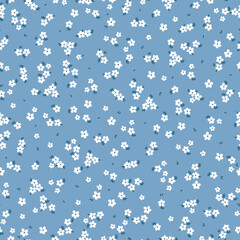 Cute floral pattern. Seamless vector texture. An elegant template for fashionable prints. Print with small white flowers, dark blue leaves. blue  background.
