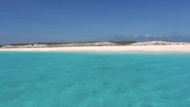 Sail on turquoise sea toward Cayo de agua lighthouse island, texture water 