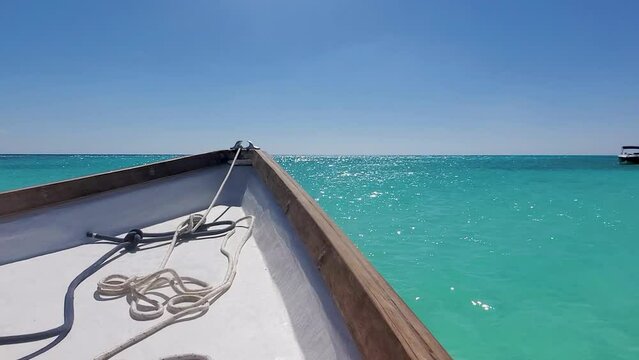 Sun Shining On Water and Boat Floating on turquoise water, caribbean sea