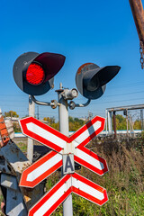 Railway traffic lights with a red signal. Railway and road crossing. Forbidding Motion signal.