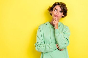 Photo portrait of pretty young woman look skeptical empty space unsatisfied wear trendy green...