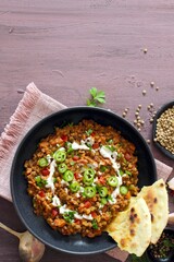 Lentil with vegetables served with sream and naan bread. Top view. Vegetarian and vegan food.