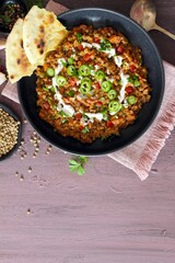 Lentil with vegetables served with sream and naan bread. Top view. Vegetarian and vegan food.