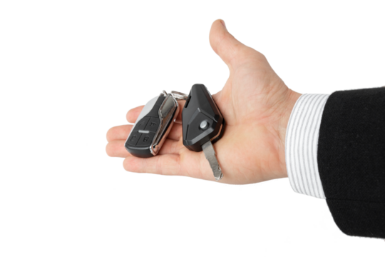 car key with key fob on male palm isolated on white