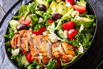Mediterranean grilled Chicken Salad in black bowl