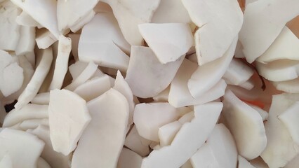 A pile of fresh coconut meat in the plastic basket for making coconut milk