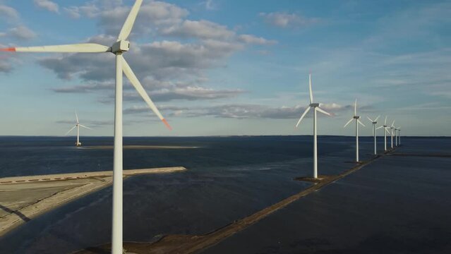 Rotating Wind Turbines Offshore Near Thisted, Denmark. Aerial Drone Shot