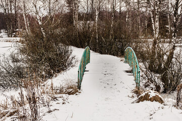 Small bridge in winter snowy weather