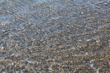 Seashore covered by a wave close up view from above